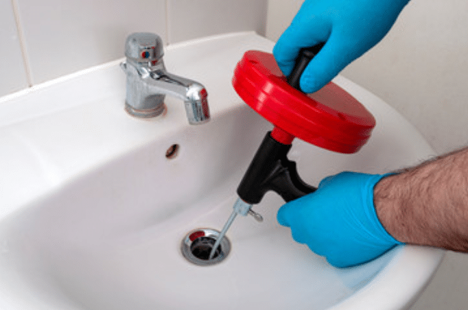 Manual drain snake tool to unclog a bathroom sink